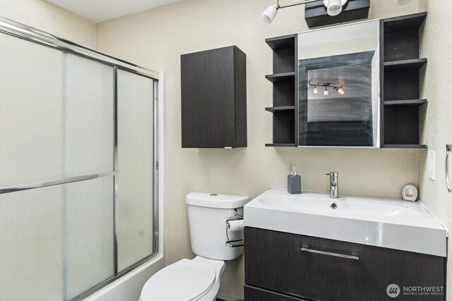 full bath featuring vanity and toilet