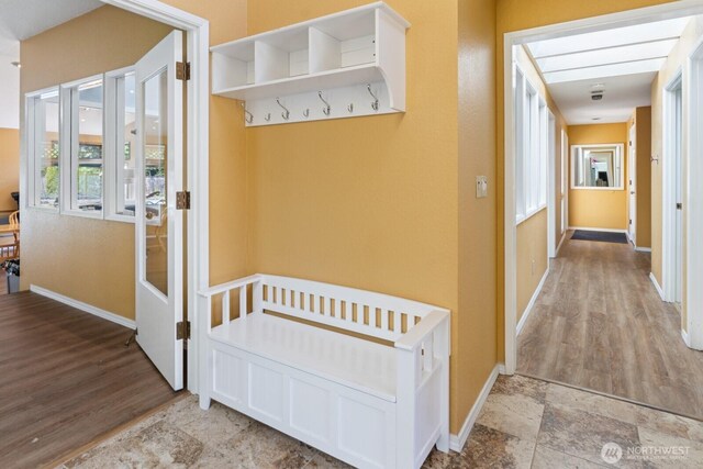 hall featuring baseboards and wood finished floors