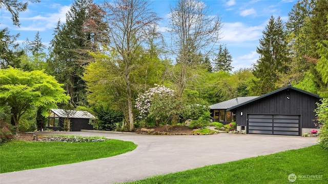 exterior space featuring a lawn, driveway, and a garage