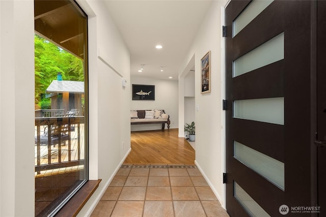 corridor featuring recessed lighting and baseboards