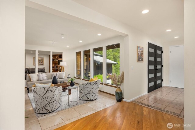 living area featuring recessed lighting, baseboards, and tile patterned floors
