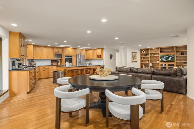 dining space featuring recessed lighting, visible vents, and light wood-type flooring