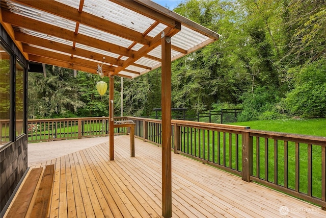 wooden terrace featuring a yard, a pergola, and fence