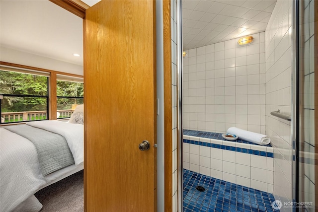 full bathroom with recessed lighting and tiled shower