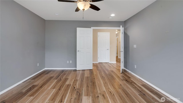 interior space with baseboards, a ceiling fan, recessed lighting, and wood finished floors