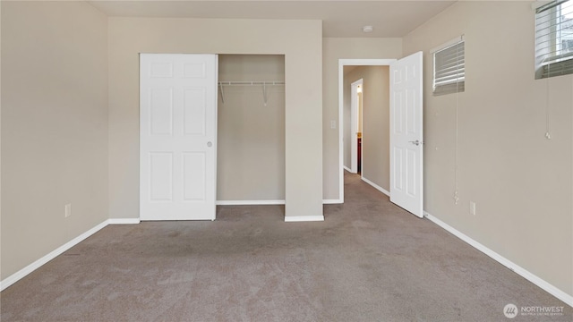 unfurnished bedroom with carpet floors and baseboards