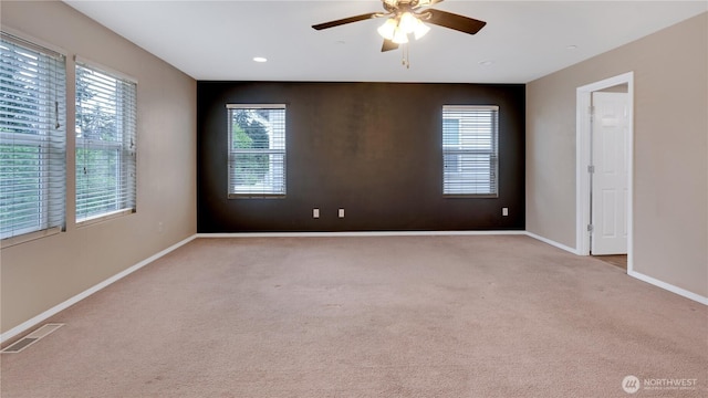 carpeted spare room featuring baseboards, a ceiling fan, recessed lighting, and visible vents