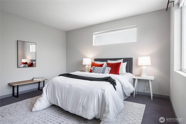 bedroom with carpet floors and baseboards