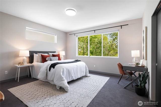 carpeted bedroom featuring baseboards