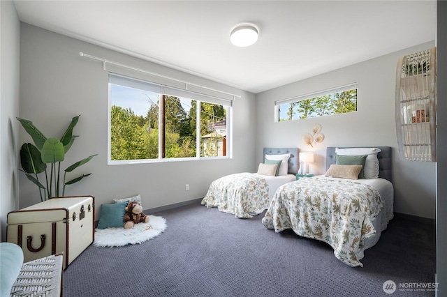 carpeted bedroom featuring baseboards