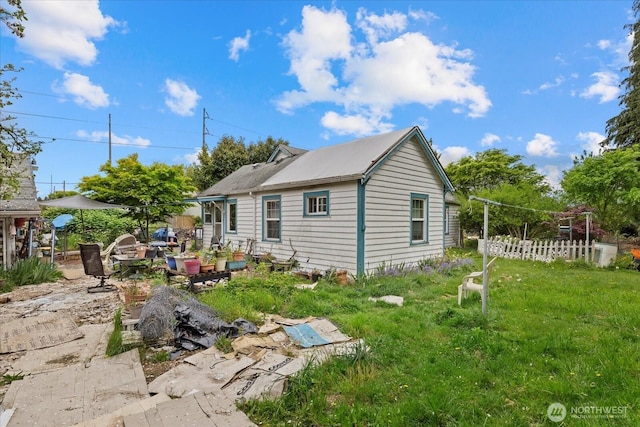 back of house with fence