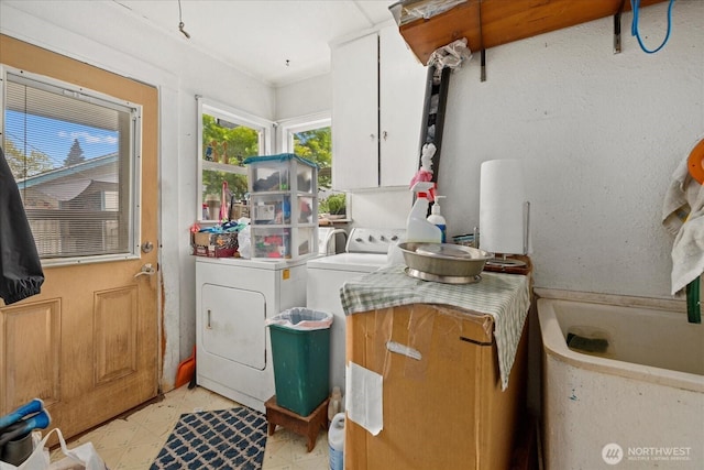 clothes washing area with cabinet space and washing machine and clothes dryer
