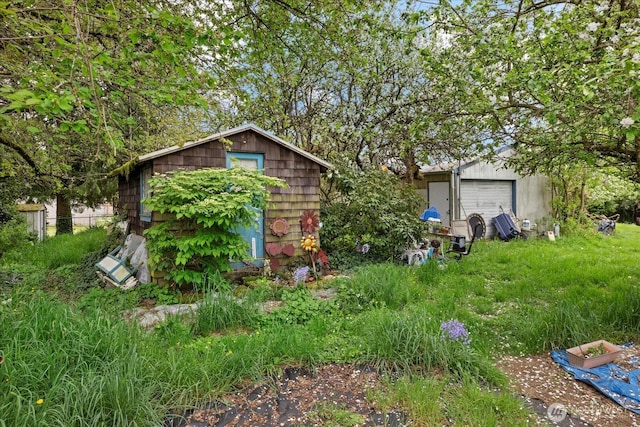 exterior space featuring an outdoor structure and a detached garage