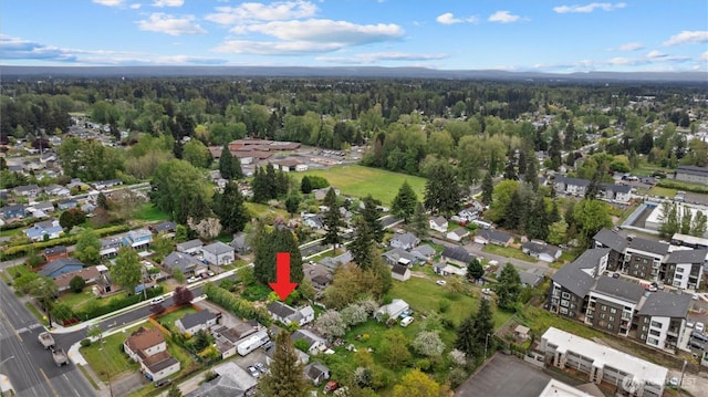 drone / aerial view featuring a forest view and a residential view