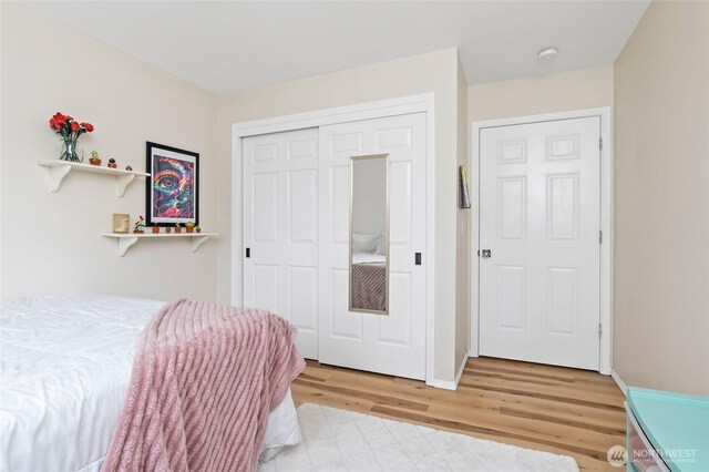 bedroom with a closet and wood finished floors