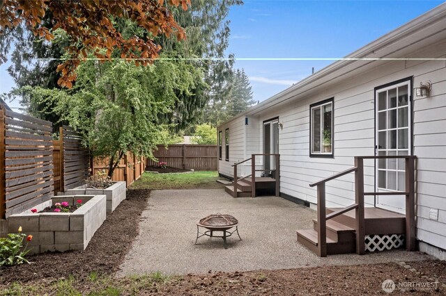 view of yard with a fenced backyard, a patio area, and an outdoor fire pit
