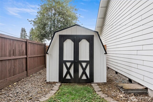 view of shed featuring fence