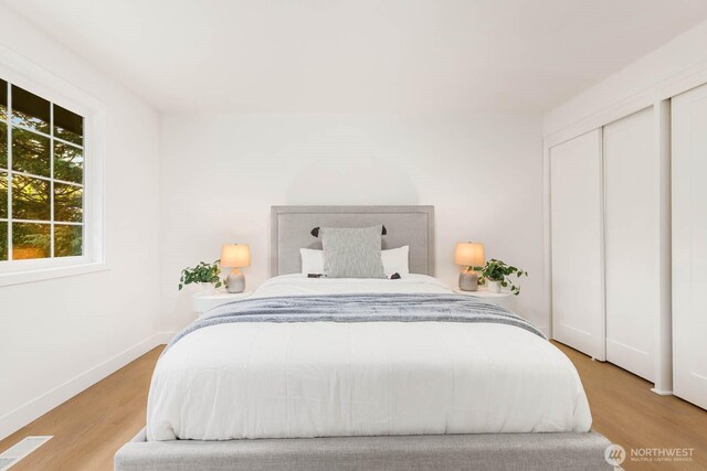 bedroom featuring baseboards and wood finished floors