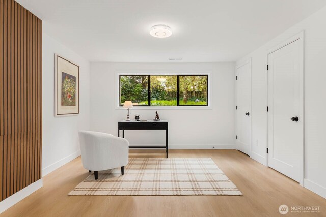 sitting room featuring baseboards, wood finished floors, and visible vents