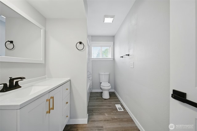 full bath with vanity, curtained shower, toilet, baseboards, and wood finished floors