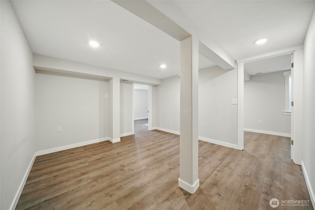 finished basement featuring baseboards, recessed lighting, and wood finished floors