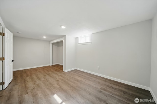 basement with baseboards, recessed lighting, and wood finished floors