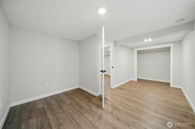 finished basement featuring baseboards, recessed lighting, and wood finished floors