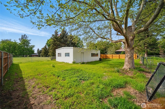 view of yard featuring an outbuilding and a fenced backyard