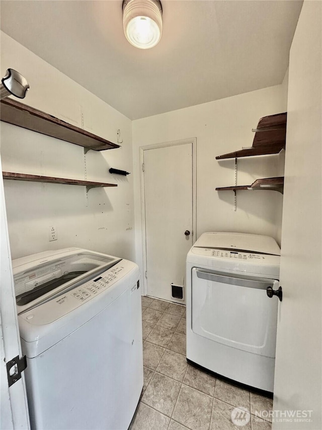 2509 SW Portland Ct, Seattle, WA 98106 - laundry room featuring washer and clothes dryer and light tile patterned floors