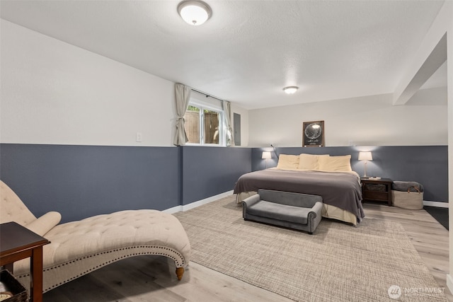 bedroom with wood finished floors and baseboards