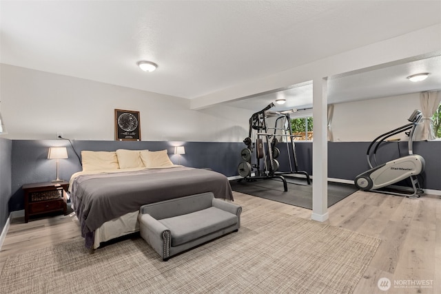 bedroom with wood finished floors and baseboards