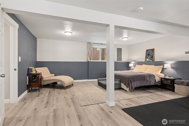 bedroom featuring wood finished floors and baseboards