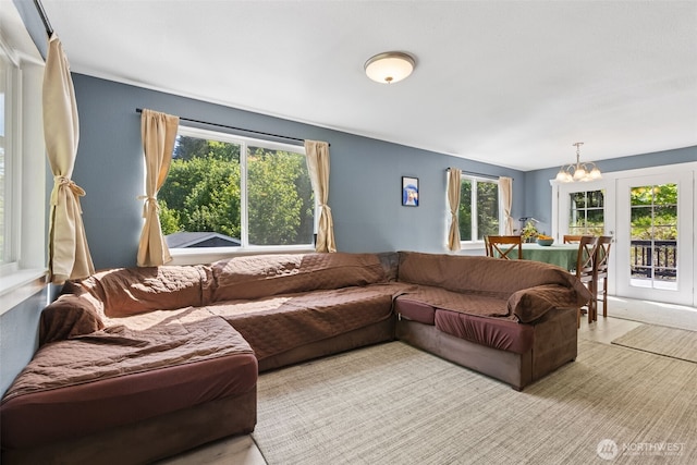 living room featuring plenty of natural light and a chandelier