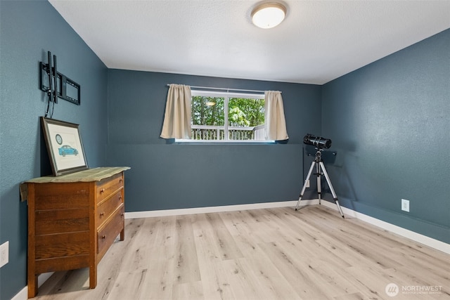 bedroom featuring wood finished floors and baseboards