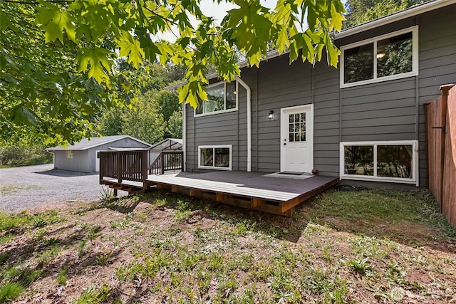 rear view of property featuring a wooden deck