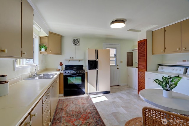 4802 S Austin St, Seattle, WA 98118 - kitchen featuring white refrigerator with ice dispenser, black / electric stove, a sink, washer / clothes dryer, and plenty of natural light