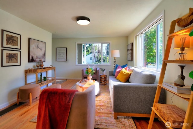4802 S Austin St, Seattle, WA 98118 - living area featuring healthy amount of natural light, wood finished floors, and baseboards