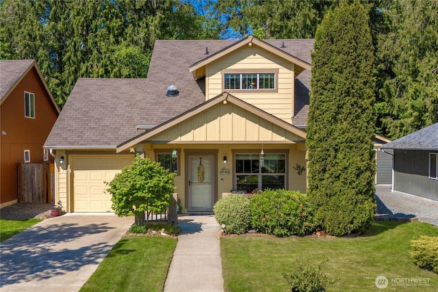 view of front of house featuring board and batten siding, driveway, a front yard, fence, and an attached garage