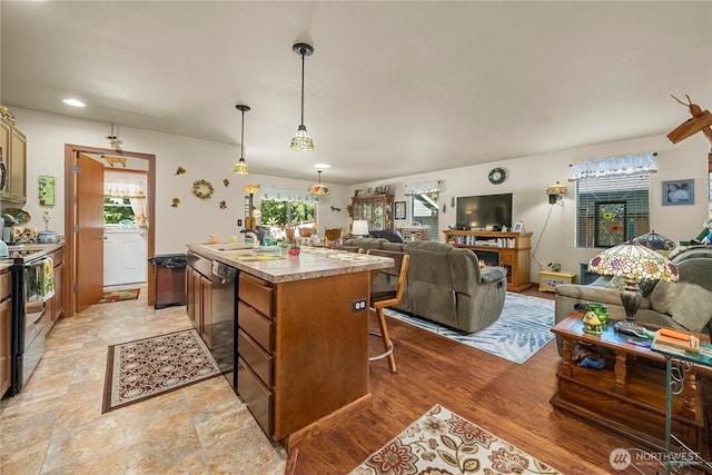 kitchen with a wealth of natural light, open floor plan, and electric stove
