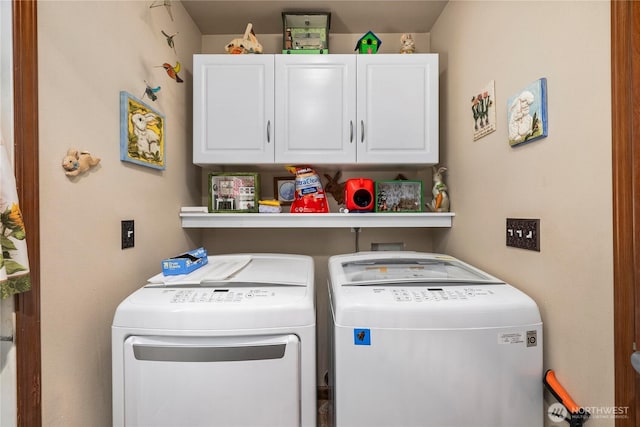 laundry area featuring cabinet space and washing machine and clothes dryer