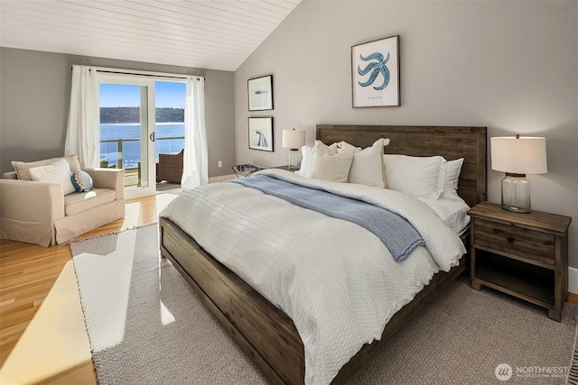 13967 SW 248th St, Vashon, WA 98070 - bedroom with light wood-style floors, access to exterior, baseboards, a water view, and vaulted ceiling
