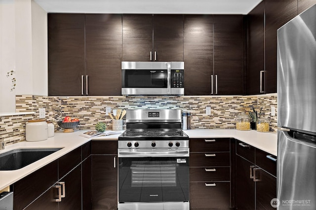 kitchen featuring light countertops, modern cabinets, and stainless steel appliances