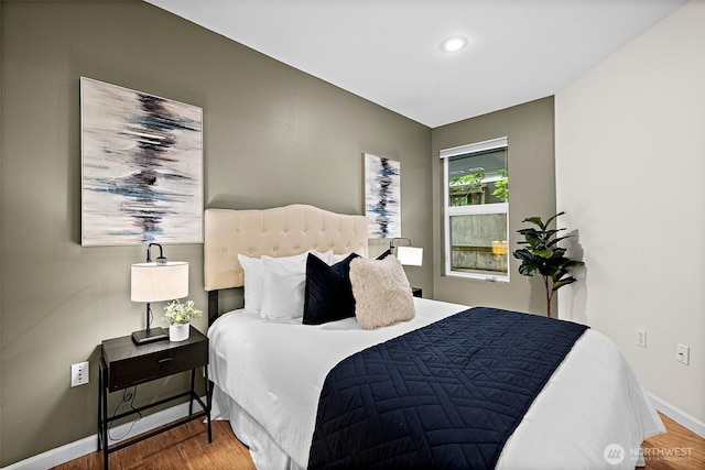 bedroom with baseboards and wood finished floors
