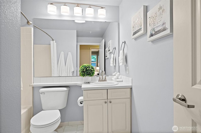 bathroom featuring vanity, shower / tub combo, and toilet