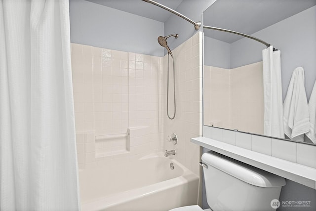 bathroom featuring shower / bath combo with shower curtain and toilet