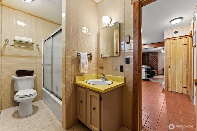 225C Lost River Rd, Mazama, WA 98833 - full bath featuring vanity, a wood stove, tile walls, tile patterned floors, and combined bath / shower with glass door