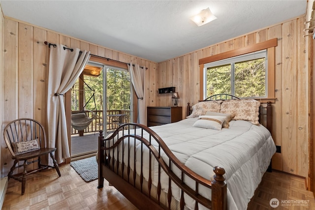 225C Lost River Rd, Mazama, WA 98833 - bedroom featuring wooden walls and access to exterior