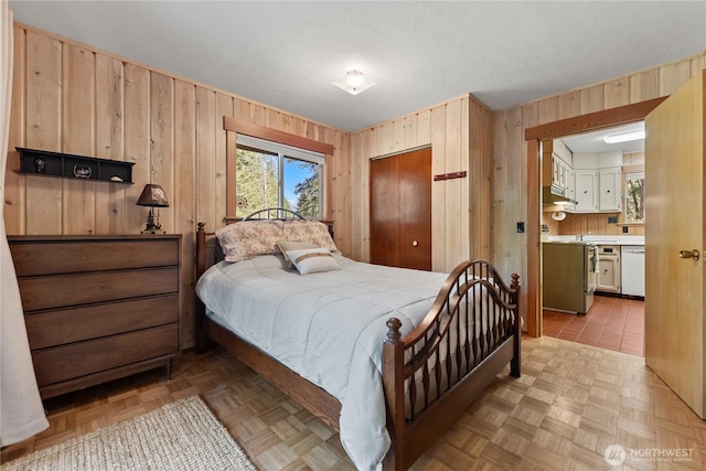 225C Lost River Rd, Mazama, WA 98833 - bedroom featuring wooden walls, a closet, and connected bathroom