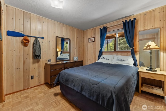 225C Lost River Rd, Mazama, WA 98833 - bedroom featuring baseboards, wood walls, and a textured ceiling
