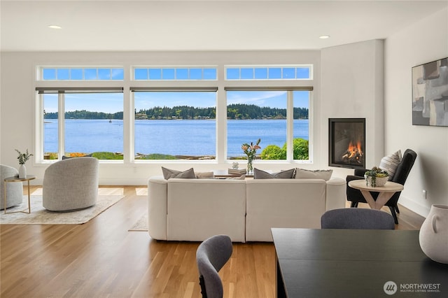 4582 Point White Dr NE, Bainbridge Island, WA 98110 - living area featuring plenty of natural light, wood finished floors, a water view, and recessed lighting